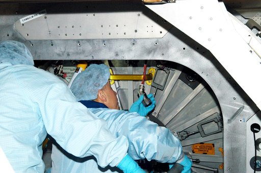 KENNEDY SPACE CENTER, FLA. - Astronaut Tim Kopra aids in Intravehicular Activity (IVA) constraints testing on the Italian-built Node 2, a future element of the International Space Station.  The second of three Station connecting modules, the Node 2 attaches to the end of the U.S. Lab and provides at