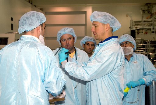KENNEDY SPACE CENTER, FLA. - Astronaut Tim Kopra (second from right) talks with workers in the Space Station Processing Facility about the Intravehicular Activity (IVA) constraints testing on the Italian-built Node 2, a future element of the International Space Station.  .  The second of three Stati
