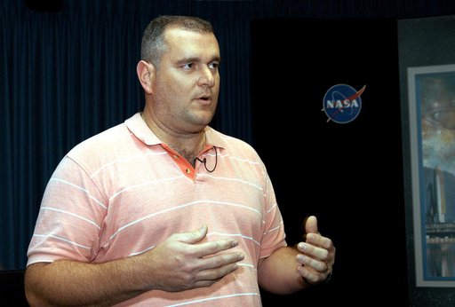 KENNEDY SPACE CENTER, FLA. - Armando Oliu, Final Inspection Team lead for the Shuttle program, speaks to reporters about the aid the Image Analysis Lab is giving the FBI in a kidnapping case.  Oliu oversees the image lab that is using an advanced SGI® TP9500 data management system to review the tape
