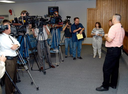 KENNEDY SPACE CENTER, FLA. - Reporters are eager to hear from Armando Oliu about the aid the Image Analysis Lab is giving the FBI in a kidnapping case.  Oliu, Final Inspection Team lead for the Shuttle program, oversees the lab that is using an advanced SGI® TP9500 data management system to review t
