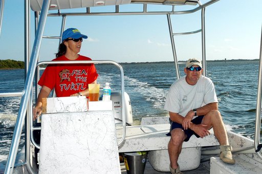 KENNEDY SPACE CENTER, FLA. - Karen Holloway-Adkins, KSC wildlife specialist, takes the helm on the boat as she begins a tour of the Banana River.  She is studying the life history of sea turtles, especially what they eat, where they lay their eggs and what factors might harm their survival.  On the 