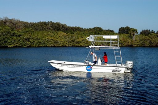 KENNEDY SPACE CENTER, FLA. - Karen Holloway-Adkins, KSC wildlife specialist, at the helm of a boat on the Banana River, heads for a research area.  She is studying the life history of sea turtles, especially what they eat, where they lay their eggs and what factors might harm their survival.  On the