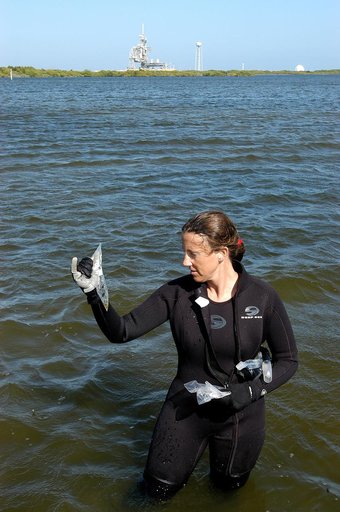 KENNEDY SPACE CENTER, FLA. - Karen Holloway-Adkins, KSC wildlife specialist, holds a sample of the sea grass she collected from the floor of the Banana River.  She is studying the life history of sea turtles, especially what they eat, where they lay their eggs and what factors might harm their survi