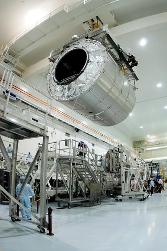 KENNEDY SPACE CENTER, FLA. - A worker on the floor watches as the Multi-Purpose Logistics Module Raffaello moves toward another work stand in the Space Station Processing Facility.  Raffaello is the second MPLM built by the Italian Space Agency, serving as a reusable logistics carrier and primary de
