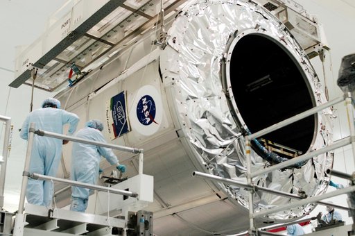 KENNEDY SPACE CENTER, FLA. - Workers in the Space Station Processing Facility secure the Multi-Purpose Logistics Module Raffaello onto a new work stand.  Raffaello is the second MPLM built by the Italian Space Agency, serving as a reusable logistics carrier and primary delivery system to resupply an