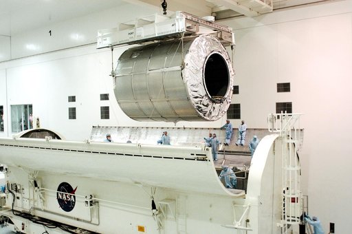 KENNEDY SPACE CENTER, FLA. - The Multi-Purpose Logistics Module Donatello is suspended by cables over the payload canister in the Space Station Processing Facility.  Previously housed in the Operations and Checkout Building, Donatello was brought into the SSPF for routine testing.  This is the first