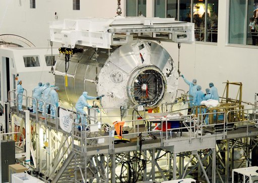KENNEDY SPACE CENTER, FLA. - In the Space Station Processing Facility,  workers help the Multi-Purpose Logistics Module Donatello settle onto a work stand.  Previously housed in the Operations and Checkout Building, Donatello was brought into the SSPF for routine testing.  This is the first time all