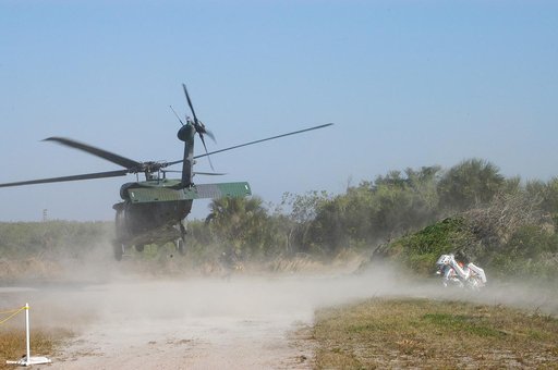 KENNEDY SPACE CENTER, FLA. - A helicopter is landing near rescue team members taking part in a “Mode VII” emergency landing simulation at Kennedy Space Center.  The purpose of Mode VII is to exercise emergency preparedness personnel, equipment and facilities in rescuing astronauts from a downed orbi