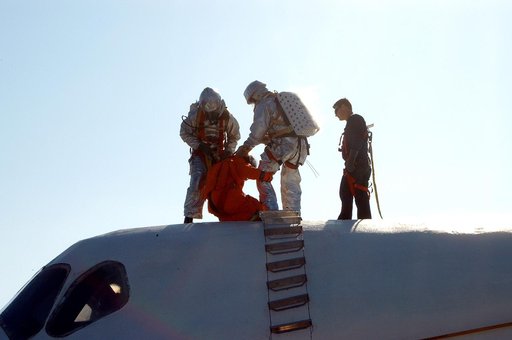 KENNEDY SPACE CENTER, FLA. - Emergency crew members “rescue” an astronaut from inside the orbiter crew compartment mock-up that is the scene of a “Mode VII” emergency landing simulation at Kennedy Space Center.  The purpose of the Mode VII is to exercise emergency preparedness personnel, equipment a