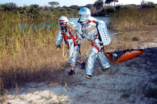 KENNEDY SPACE CENTER, FLA. - Emergency crew members transport an “injured” astronaut during a “Mode VII” emergency landing simulation at Kennedy Space Center.  The purpose of the Mode VII is to exercise emergency preparedness personnel, equipment and facilities in rescuing astronauts from a downed o