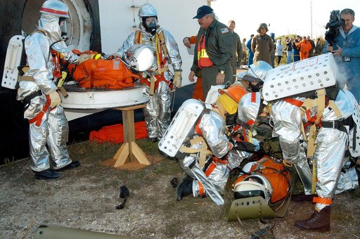 KENNEDY SPACE CENTER, FLA. - Emergency crew members help an “injured” astronaut from the orbiter crew compartment mock-up during a “Mode VII” emergency landing simulation at Kennedy Space Center.  Another is on the ground.  The purpose of the Mode VII is to exercise emergency preparedness personnel,