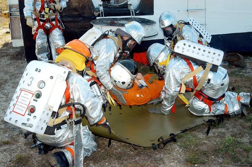KENNEDY SPACE CENTER, FLA. - Emergency crew members help an “injured” astronaut who was removed from the orbiter crew compartment mock-up during a “Mode VII” emergency landing simulation at Kennedy Space Center.  The purpose of the Mode VII is to exercise emergency preparedness personnel, equipment 