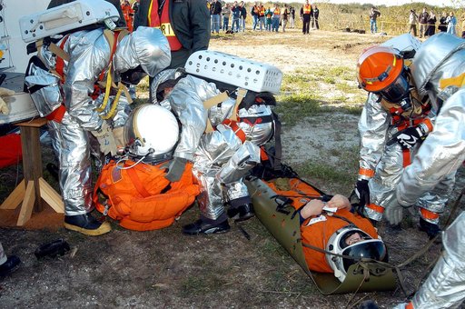 KENNEDY SPACE CENTER, FLA. - Emergency crew members assess medical needs on “injured” astronauts removed from the orbiter crew compartment mock-up during a “Mode VII” emergency landing simulation at Kennedy Space Center.  The purpose of the Mode VII is to exercise emergency preparedness personnel, e