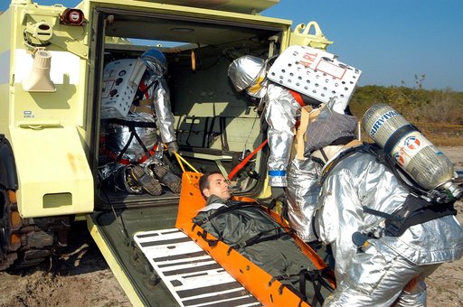KENNEDY SPACE CENTER, FLA. - An “injured” rescue worker is lifted into an M-113 armored personnel carrier provided for transportation during a “Mode VII” emergency landing simulation at Kennedy Space Center.  The purpose of the Mode VII is to exercise emergency preparedness personnel, equipment and 
