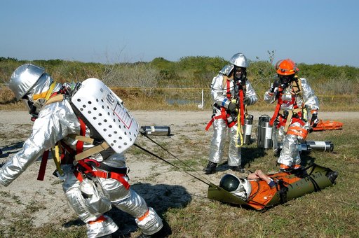 KENNEDY SPACE CENTER, FLA. - Emergency crew members transport an “injured”  astronaut during a “Mode VII” emergency landing simulation at Kennedy Space Center.  The purpose of the Mode VII is to exercise emergency preparedness personnel, equipment and facilities in rescuing astronauts from a downed 