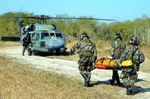 KENNEDY SPACE CENTER, FLA. - A helicopter rescue team carries another “injured” astronaut to a helicopter for transportation to a local hospital.  They are all taking part in a “Mode VII” emergency landing simulation at Kennedy Space Center.  The purpose of the Mode VII is to exercise emergency prep