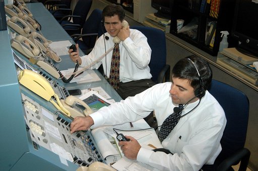 KENNEDY SPACE CENTER, FLA. - In the Launch Control Center, Robert Holl (left),  Landing Recovery directo, and Donald Hammel, from the Shuttle Project Office, are in contact with the leaders of the “Mode VII” emergency landing simulation at Kennedy Space Center.  The simulation is being managed and d