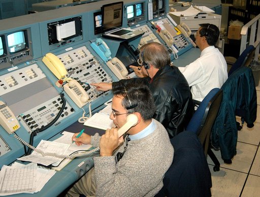 KENNEDY SPACE CENTER, FLA. - In the Launch Control Center, officials monitor the “Mode VII” emergency landing simulation being conducted at Kennedy Space Center and managed and directed from the LCC.  From left are Dr. Luis Moreno and Dr. David Reed, with Bionetics Life Sciences, and Dr. Philip Scar
