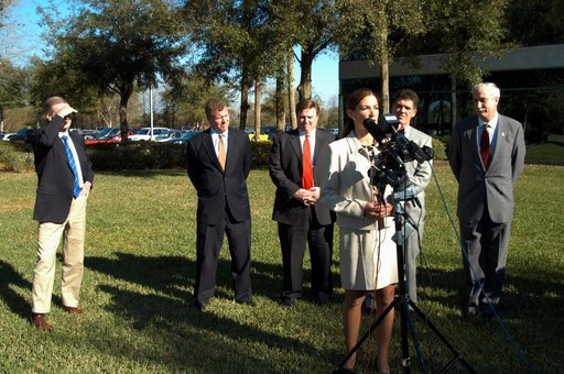 KENNEDY SPACE CENTER, FLA. - Pamella J. Dana, Ph.D., director, Office of Tourism, Trade, and Economic Development in Florida, talks to the media at the Central Florida Research Park, near Orlando.  She gave a presentation to NASA Administrator Sean O’Keefe (far right) about the assets of the researc