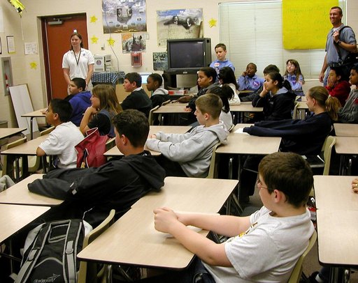 KENNEDY SPACE CENTER, FLA. - Students at Garland V. Stewart Magnet Middle School, a NASA Explorer School (NES) in Tampa, Fla., listen attentively to astronaut Kay Hire.  She and Center Director Jim Kennedy were at the school to share the agency’s new vision for space exploration with the next genera