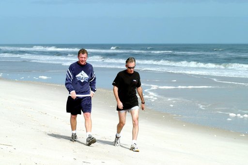 KENNEDY SPACE CENTER, FLA. - Congressman Tom Feeney (left) walks along the beach at Kennedy Space Center.  Accompanying him is Ricky D. O’Quinn, a member of the KSC SWAT team. The congressman concluded his walks along the entire coastline of Florida’s 24th District March 1 on the beach at Kennedy Sp