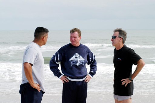 KENNEDY SPACE CENTER, FLA. - Congressman Tom Feeney (center) pauses on his walk along the beach at Kennedy Space Center.  With him are Ivan Osores (left), with Security, and Ricky D. O’Quinn, with the KSC SWAT team.  During January and February, Congressman Feeney traveled the entire coastline of Fl