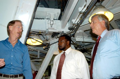 KENNEDY SPACE CENTER, FLA. - On a tour of the Orbiter Processing Facility, Center Director Jim Kennedy (right) and Deputy Director Woodrow Whitlow Jr. (center) talk to Tom Roberts, who is with United Space Alliance, about work being done on the orbiter Endeavour.  The vehicle is in its Orbiter Major