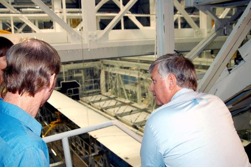 KENNEDY SPACE CENTER, FLA. - On a tour of the Orbiter Processing Facility, Center Director Jim Kennedy (right) looks over some of the work being done on the orbiter Endeavour.  At left is Tom Roberts, who is with United Space Alliance.  Endeavour is in its Orbiter Major Modification period, which be