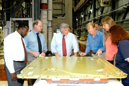 KENNEDY SPACE CENTER, FLA. - On a tour of the Orbiter Processing Facility, Center Director Jim Kennedy (center) and Deputy Director Woodrow Whitlow Jr. (far left) look at the external tank door corrosion work being done on Endeavour.  Next to Whitlow is Bruce Buckingham, assistant to the deputy dire