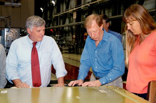 KENNEDY SPACE CENTER, FLA. - On a tour of the Orbiter Processing Facility, Center Director Jim Kennedy (left) looks at an external tank door corrosion work being done on Endeavour.  At right, Tom Roberts, Airframe Engineering System specialist with United Space Alliance, is describing the work. At r