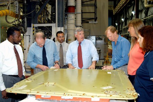 KENNEDY SPACE CENTER, FLA. - On a tour of the Orbiter Processing Facility, Center Director Jim Kennedy (center) and Deputy Director Woodrow Whitlow Jr. (far left) look at the external tank door corrosion work being done on Endeavour.  Next to Whitlow is Bruce Buckingham, assistant to the deputy dire