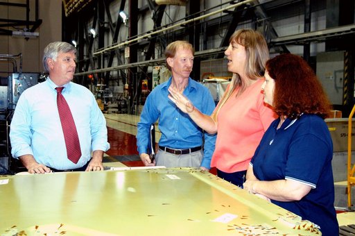 KENNEDY SPACE CENTER, FLA. - On a tour of the Orbiter Processing Facility, Center Director Jim Kennedy (left) listens to Kathy Laufenberg, Orbiter Airframe Engineering ground area manager, with United Space Alliance, about corrosion work being done on the external tank door of orbiter Endeavour. On 