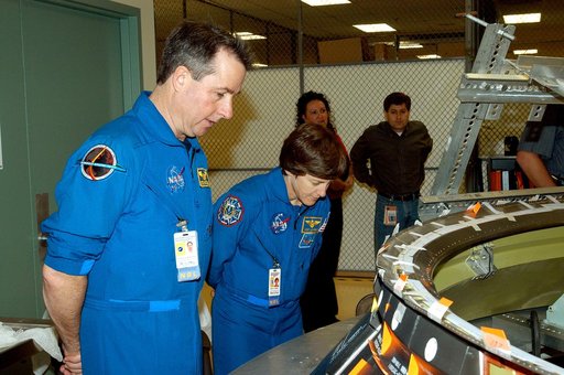 KENNEDY SPACE CENTER, FLA. -  Members of the STS-114 crew spend time in the Orbiter Processing Facility becoming familiar with Shuttle and mission equipment.  Mission Specialists Stephen Robinson (left) and Wendy Lawrence (right) look at an engine eyelet, which serves as part of the thermal protecti