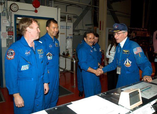 KENNEDY SPACE CENTER, FLA. - -  In the Orbiter Processing Facility, STS-114 Mission Specialists Andrew Thomas, Soichi Noguchi and Charles Camarda greet astronaut John Young (far right), who flew on the first flight of Space Shuttle Columbia with Robert Crippen.  Behind Camarda is Pilot James Kelly. 