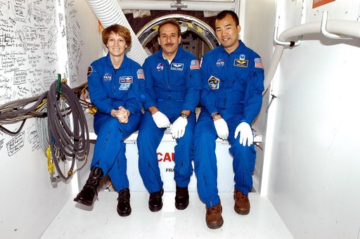 KENNEDY SPACE CENTER, FLA. - STS-114 Commander Eileen Collins and Mission Specialists Charles Camarda and Soichi Noguchi sit outside the crew hatch on the orbiter Discovery.  Noguchi is with the Japanese Aerospace and Exploration Agency.   They and other crew members are at KSC becoming familiar wit