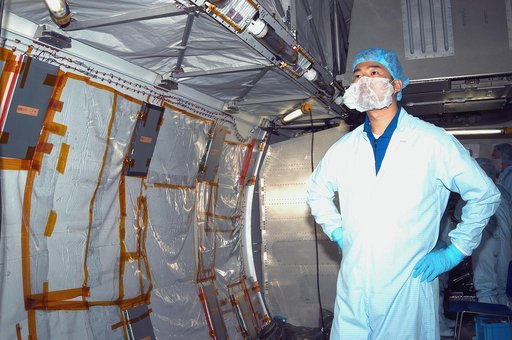KENNEDY SPACE CENTER, FLA. - STS-114 Mission Specialist Soichi Noguchi, who is with the Japanese Aerospace and Exploration Agency, looks at the inside of the Japanese Experiment Module (JEM) in the Space Station Processing Facility.  He and other crew members are at KSC becoming familiar with Shuttl