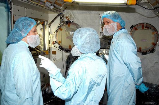 KENNEDY SPACE CENTER, FLA. - In the Space Station Processing Facility, STS-114 Mission Specialist Stephen Robinson (right) learns about the Japanese Experiment Module (JEM) from Louise Kleba (left), with United Space Alliance at KSC, and Jennifer Goldsmith (center), with USA at Johnson Space Center.