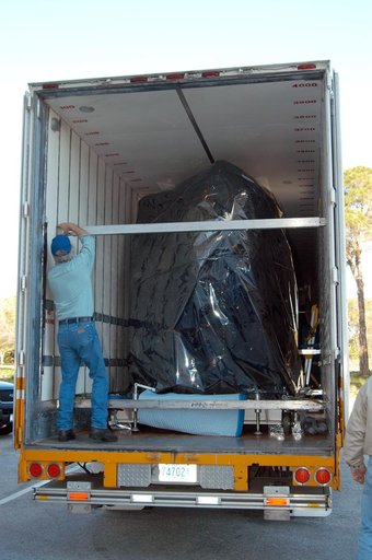 KENNEDY SPACE CENTER, FLA. -  Doors are open on the air-conditioned transportation van that carried NASA’s MESSENGER spacecraft from NASA’s Goddard Space Flight Center in Greenbelt, Md., to the Astrotech Space Operations processing facilities near KSC.  After offloading, MESSENGER - short for MErcur