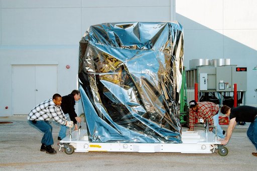 KENNEDY SPACE CENTER, FLA. -  At the Astrotech Space Operations processing facilities near KSC, workers check the moveable pallet holding NASA’s MESSENGER spacecraft.  MESSENGER - short for MErcury Surface, Space ENvironment, GEochemistry and Ranging - will be taken into a high bay clean room and em