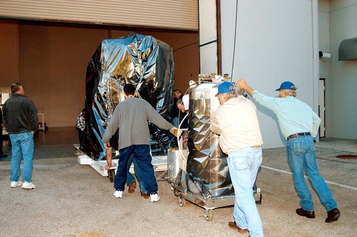 KENNEDY SPACE CENTER, FLA. -  At the Astrotech Space Operations processing facilities near KSC, workers begin moving NASA’s MESSENGER spacecraft into the building  MESSENGER - short for MErcury Surface, Space ENvironment, GEochemistry and Ranging - is being taken into a high bay clean room where emp