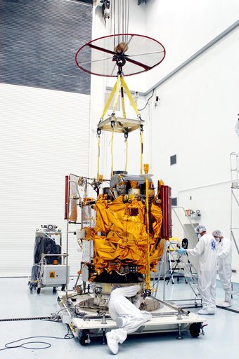 KENNEDY SPACE CENTER, FLA. -  In the high bay clean room at the Astrotech Space Operations processing facilities near KSC, workers attach an overhead crane to NASA’s MESSENGER spacecraft.  The spacecraft will be moved to a work stand where employees of the Johns Hopkins University Applied Physics La