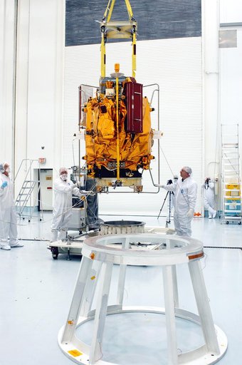 KENNEDY SPACE CENTER, FLA. -  At the Astrotech Space Operations processing facilities, an overhead crane moves NASA’s MESSENGER spacecraft toward a work stand. There employees of the Johns Hopkins University Applied Physics Laboratory, builders of the spacecraft, will perform an initial state-of-hea