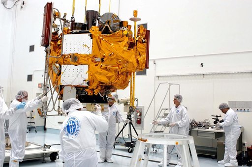KENNEDY SPACE CENTER, FLA. -  At the Astrotech Space Operations processing facilities, an overhead crane lowers NASA’s MESSENGER spacecraft onto a work stand. There employees of the Johns Hopkins University Applied Physics Laboratory, builders of the spacecraft, will perform an initial state-of-heal