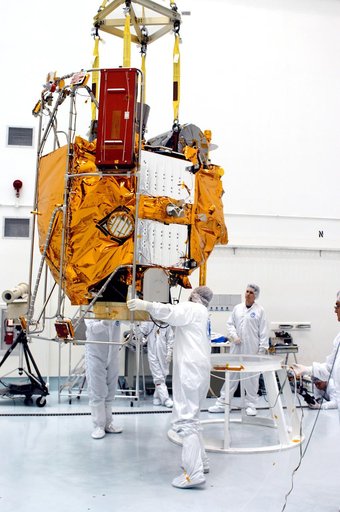KENNEDY SPACE CENTER, FLA. -  At the Astrotech Space Operations processing facilities, an overhead crane lowers NASA’s MESSENGER spacecraft onto a work stand. There employees of the Johns Hopkins University Applied Physics Laboratory, builders of the spacecraft, will perform an initial state-of-heal