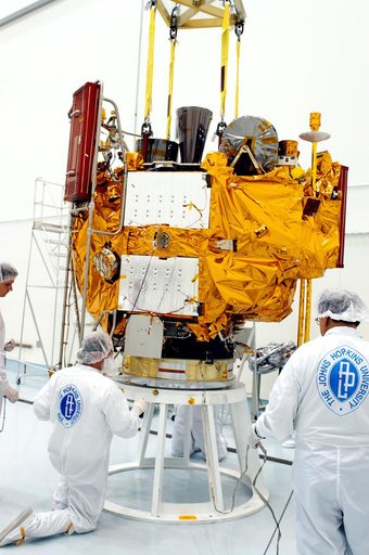 KENNEDY SPACE CENTER, FLA. -  At the Astrotech Space Operations processing facilities, workers check the placement of NASA’s MESSENGER spacecraft on a work stand. There employees of the Johns Hopkins University Applied Physics Laboratory, builders of the spacecraft, will perform an initial state-of-