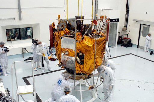 KENNEDY SPACE CENTER, FLA. -  At the Astrotech Space Operations processing facilities, workers check the placement of NASA’s MESSENGER spacecraft on a work stand. There employees of the Johns Hopkins University Applied Physics Laboratory, builders of the spacecraft, will perform an initial state-of-