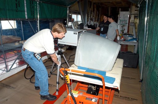 KENNEDY SPACE CENTER, FLA. -  Jim Landy, NDE specialist with United Space Alliance, sets up equipment to examine a Reinforced Carbon Carbon panel using flash thermography.  A relatively new procedure at KSC, thermography uses high intensity light to heat areas of the panels. The panels are then imme