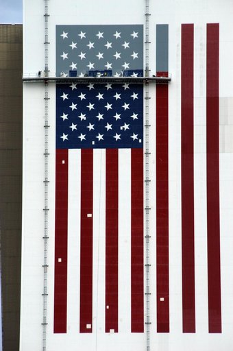 Workers painting the Flag and Meatball on the VAB
