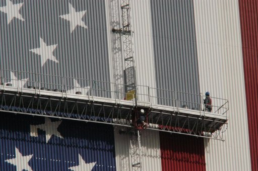 Workers painting the Flag and Meatball on the VAB