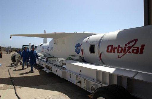 The mated Pegasus XL rocket - AIM spacecraft leaves Building 165